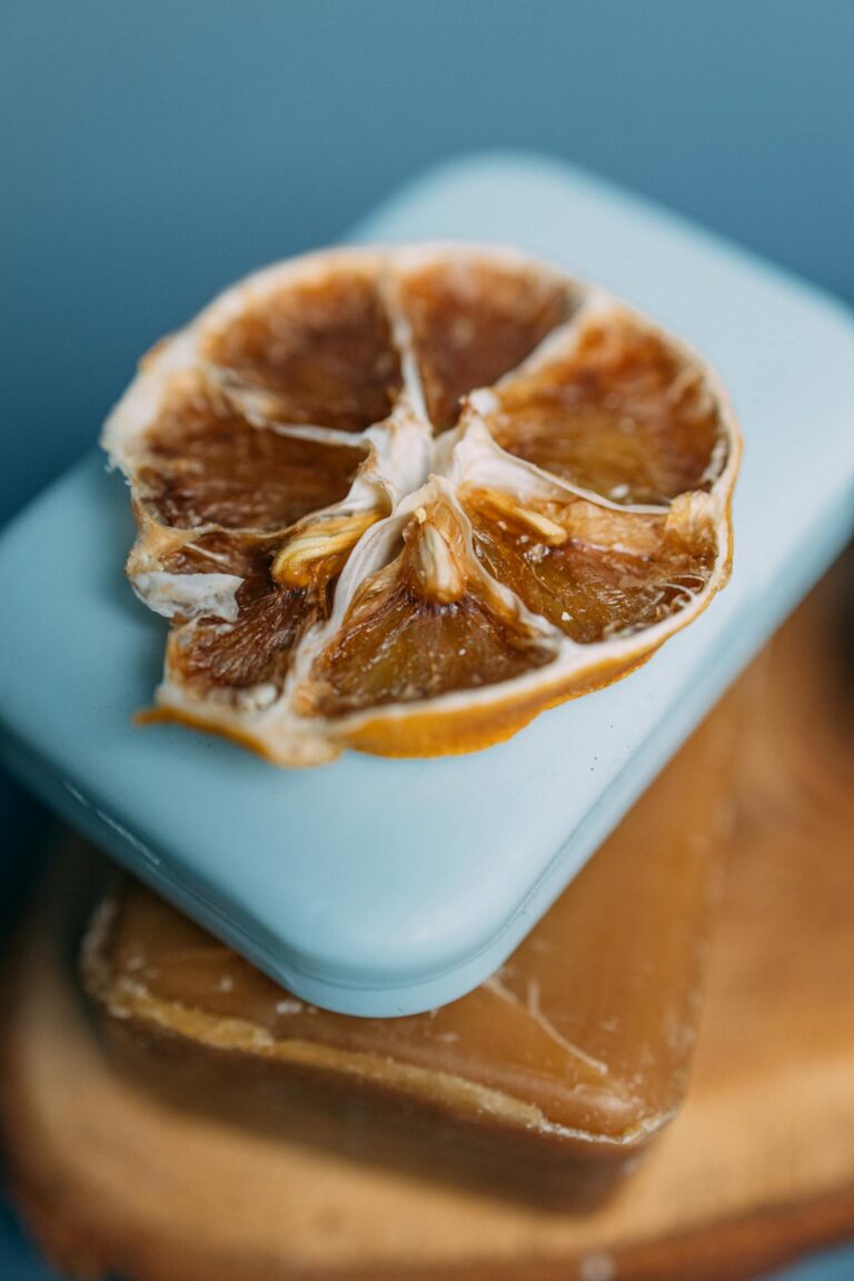 Close-up of organic soaps topped with a dried orange slice for a natural, refreshing spa feel.